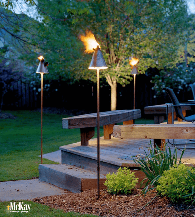 Tiki torches add a fun, resort-style aspect to your outdoor living area. Click to learn more... | McKay Landscape Lighting Omaha Nebraska