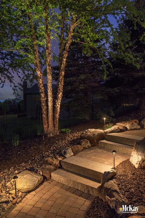 Lighting walkways and paths provide enough illumination to safely guide homeowners and guests around your property and helps prevents trips and falls. Click to learn more about path lighting... | McKay Landscape Lighting Omaha Nebraska