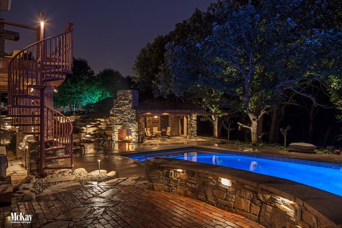 Create a luxury resort-like setting around your pool with an expertly installed landscape lighting design. | McKay Lighting Omaha Nebraska 