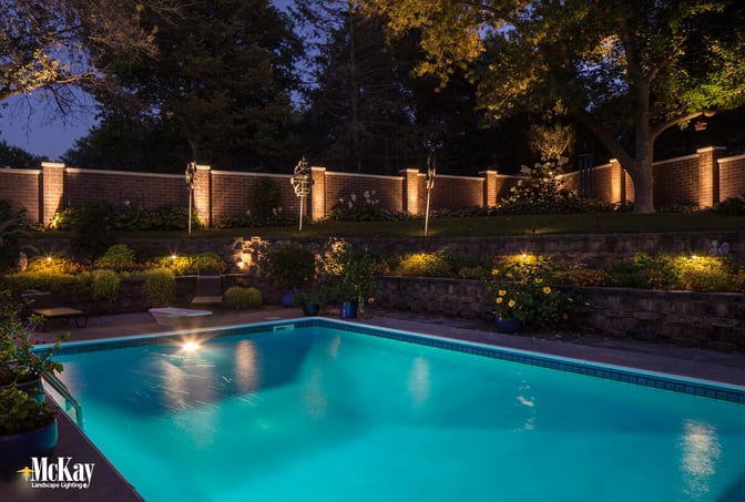 Increase the security of your pool at night by strategically lighting the edges of your yard. | McKay Landscape Lighting Omaha Nebraska