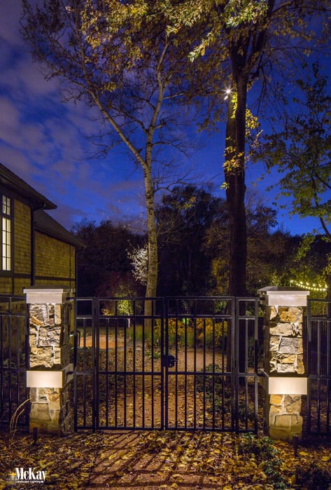 If you have a nearby tree, you could downlight the area. Light shines from above to gently illuminate the gate entrance. It's soft, yet provides ample light to increase visibility, and creates unique and interesting shadows at the same time. Learn more... | McKay Landscape Lighting - Omaha Nebraska