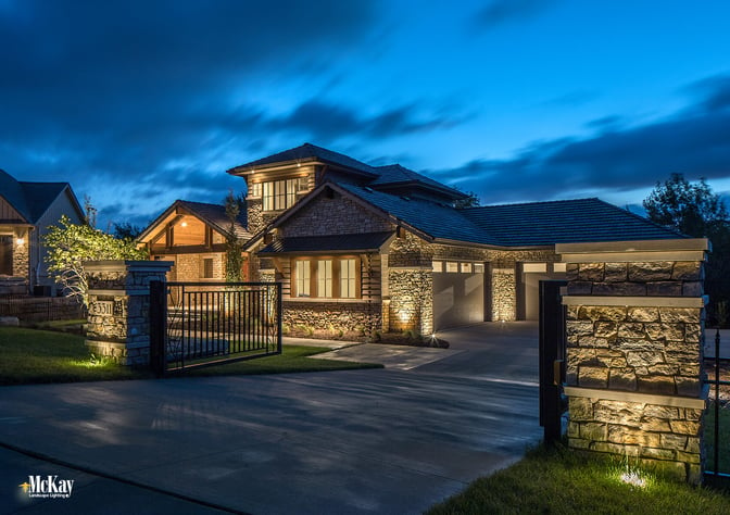 The gate lighting provides the property with an extra level of security. The two well lights in the turf grass help accent the stone and brick columns, make the address more noticeable and create ambient light. Click to learn more... | McKay Landscape Lighting - Omaha Nebraska