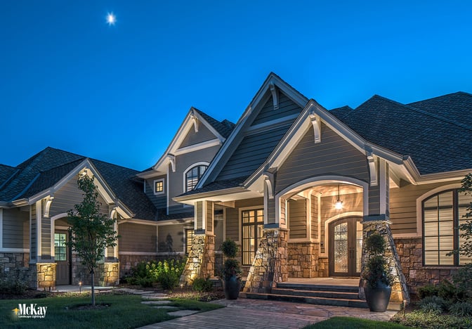 The home’s lovely natural stone and decorative corbel peaks are just some of its timeless characteristics that we wanted to highlight at night. Click to learn more about the outdoor lighting design... | McKay Landscape Lighting - Omaha, Nebraska
