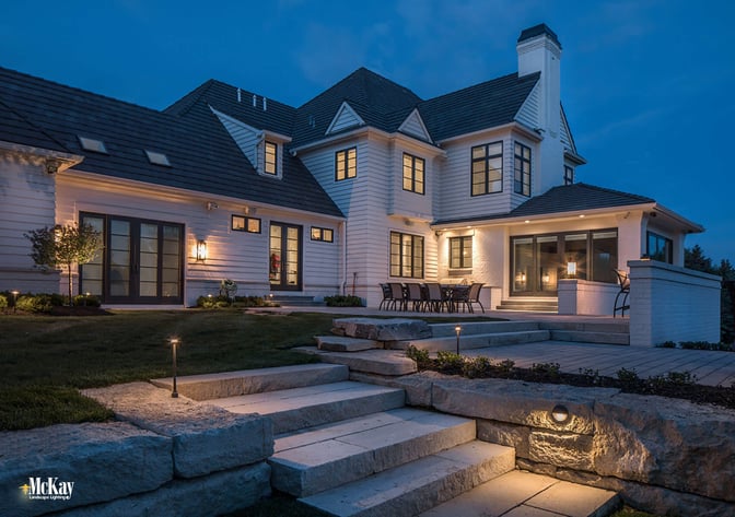 The height of the path lights provides enough visibility to help you safely to the top of the stairs, while the cascade light on the wall safely guides you down the rest of the steps and onto the lower level. Click to read more... | McKay Landscape Lighting - Omaha, Nebraska